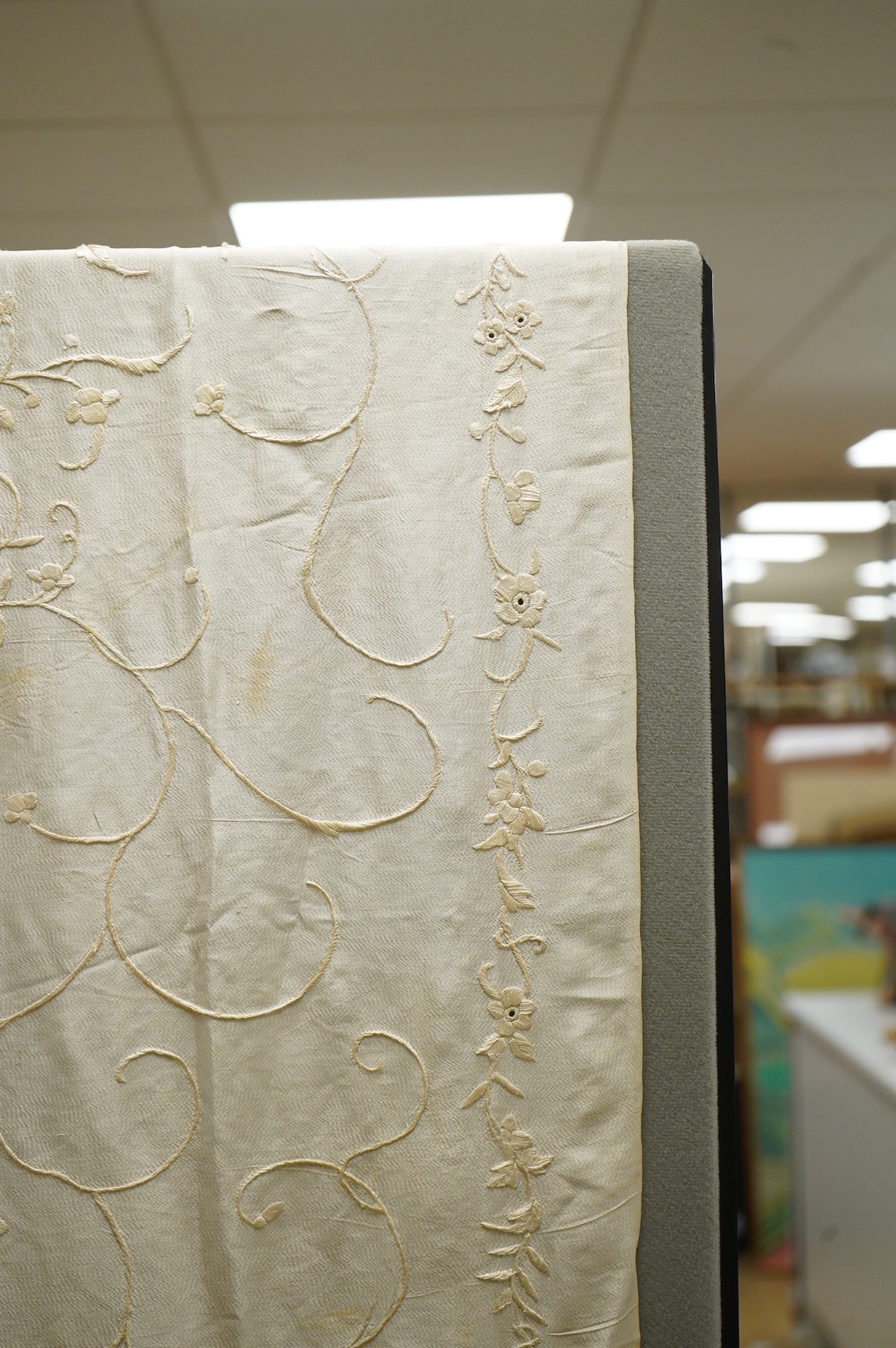 An early 20th century Chinese cream on cream silk embroidered, fringed stole, 65cm wide. Condition - some light staining.